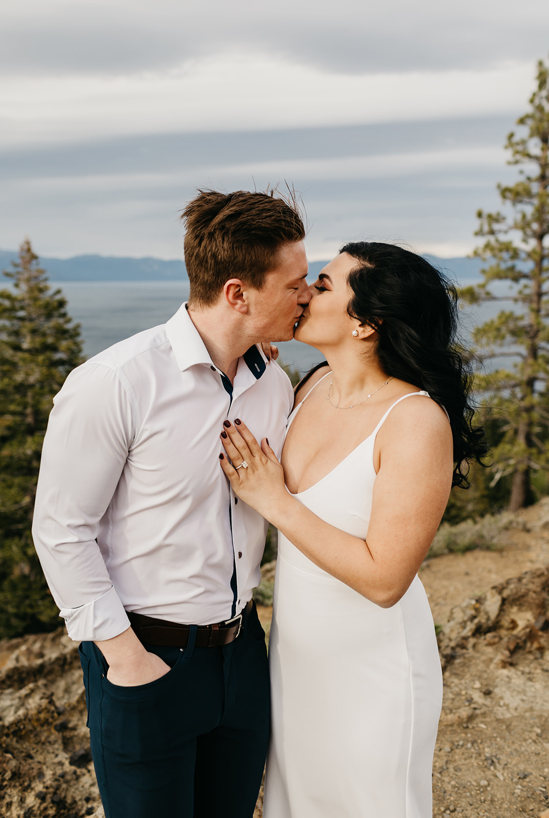 Couple kisses on mountain top in lake tahoe