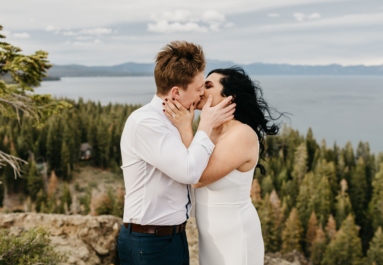 A couple kissing on a mountain top in north lake tahoe california
