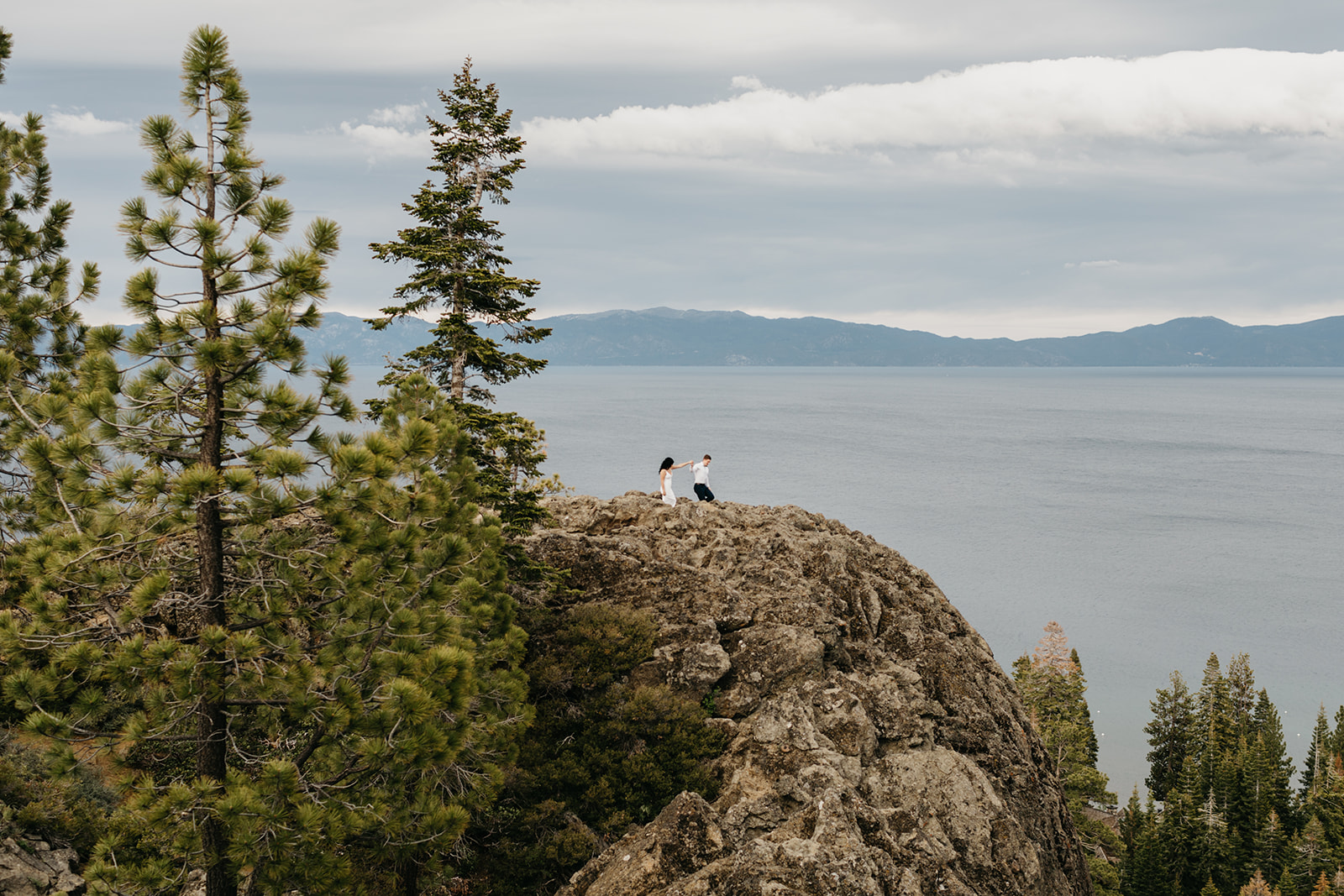 A far away photograph of a couple walking across a moutain ride line in north lake tahoe california