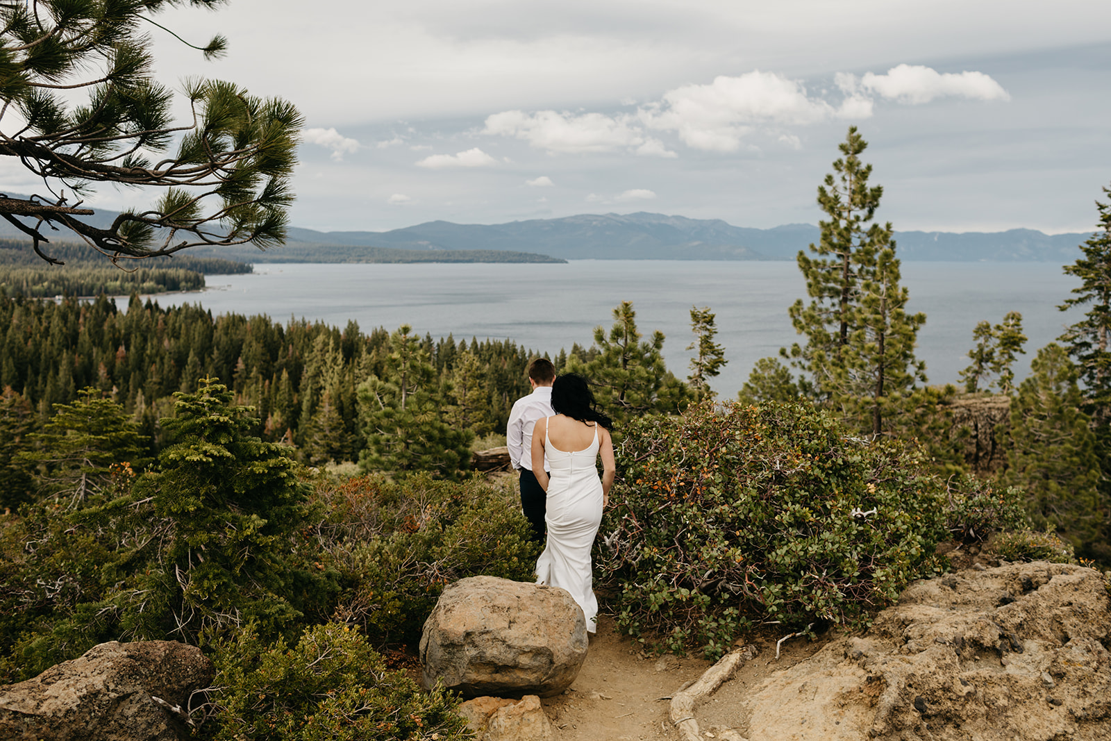 A newly engaged couple walks through tahoe national forest