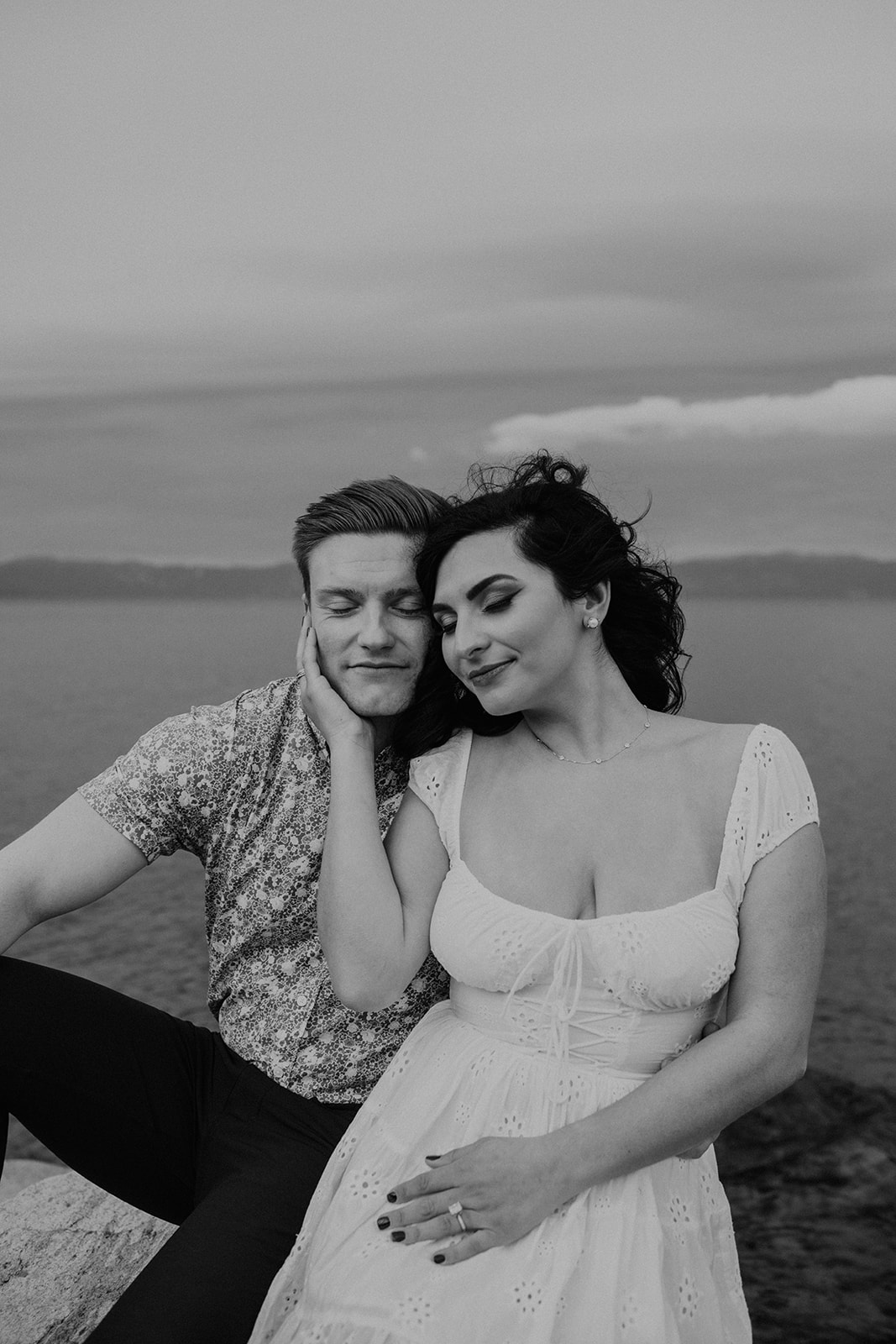 A black and white photo of a couple in lake tahoe 