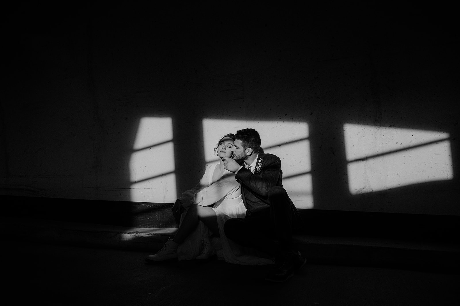 An eloped couples portraits in a pocket in light in a downtown Victoria parkade