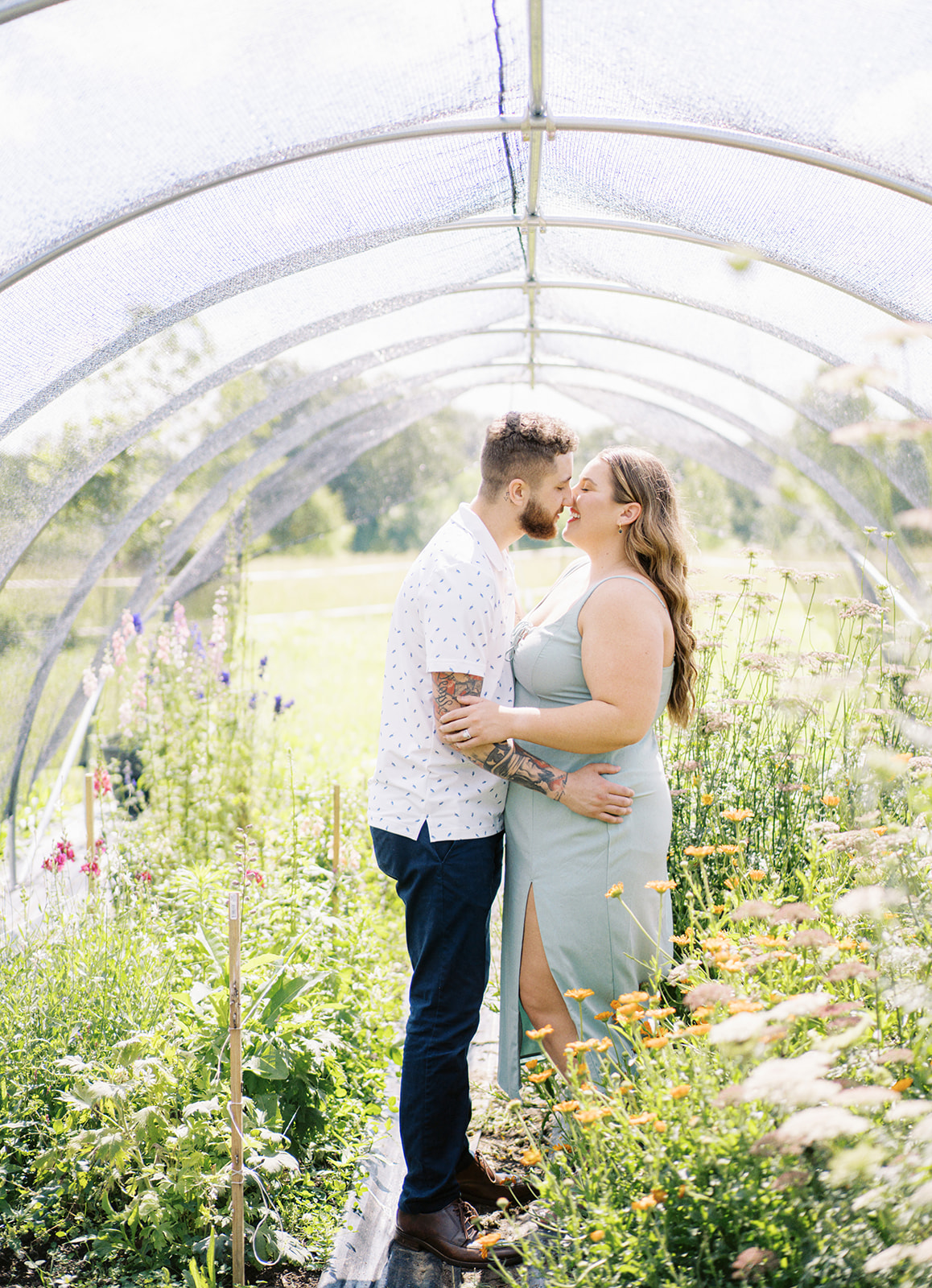The couple stands amongst the fresh flowers at Wolf Thicket Farm in North Alabama