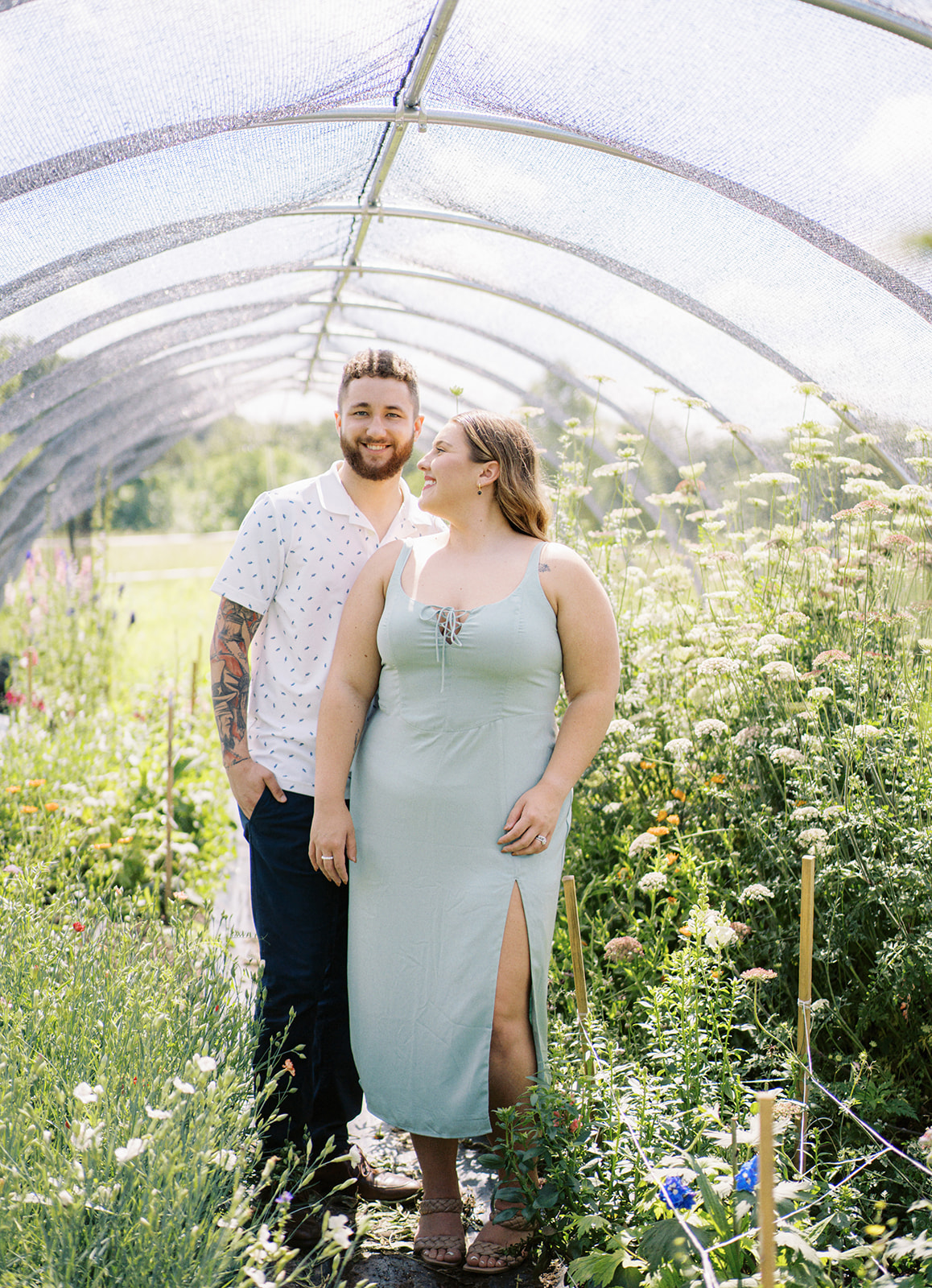 The couple stands amongst the fresh flowers at Wolf Thicket Farm in North Alabama