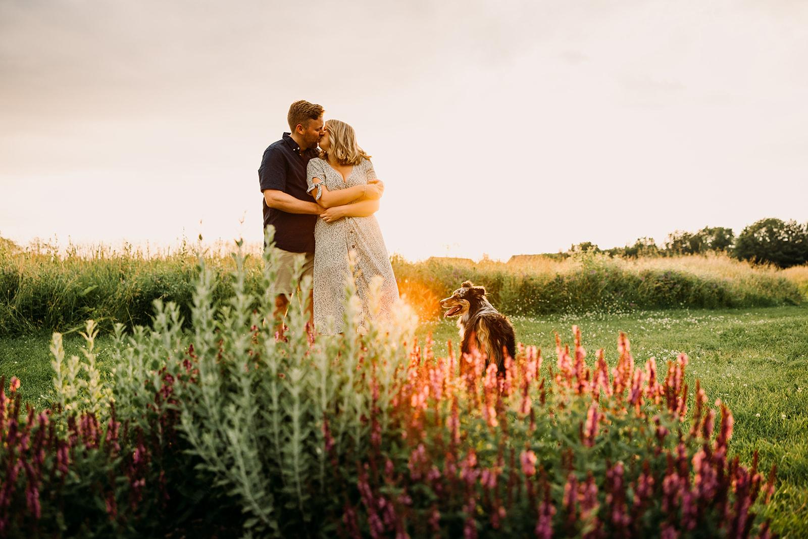 Couple's laughter fills the air in a whimsical engagement photoshoot in the field