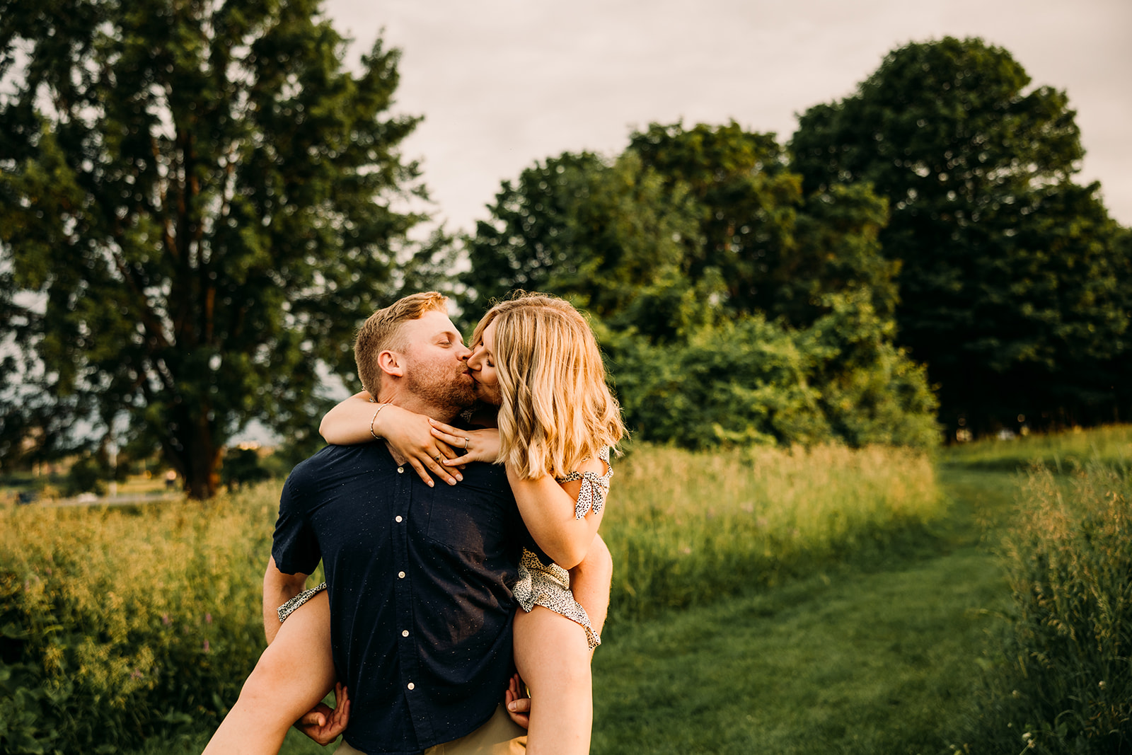 Sunset engagement photoshoot in a dreamy field