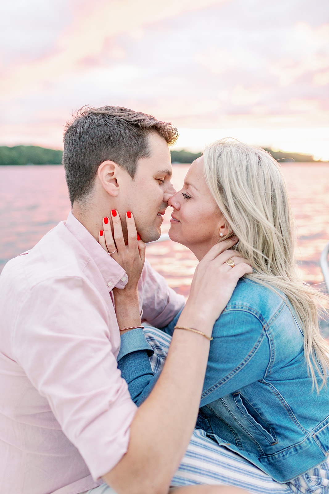 Couple kisses during engagement session at sunset