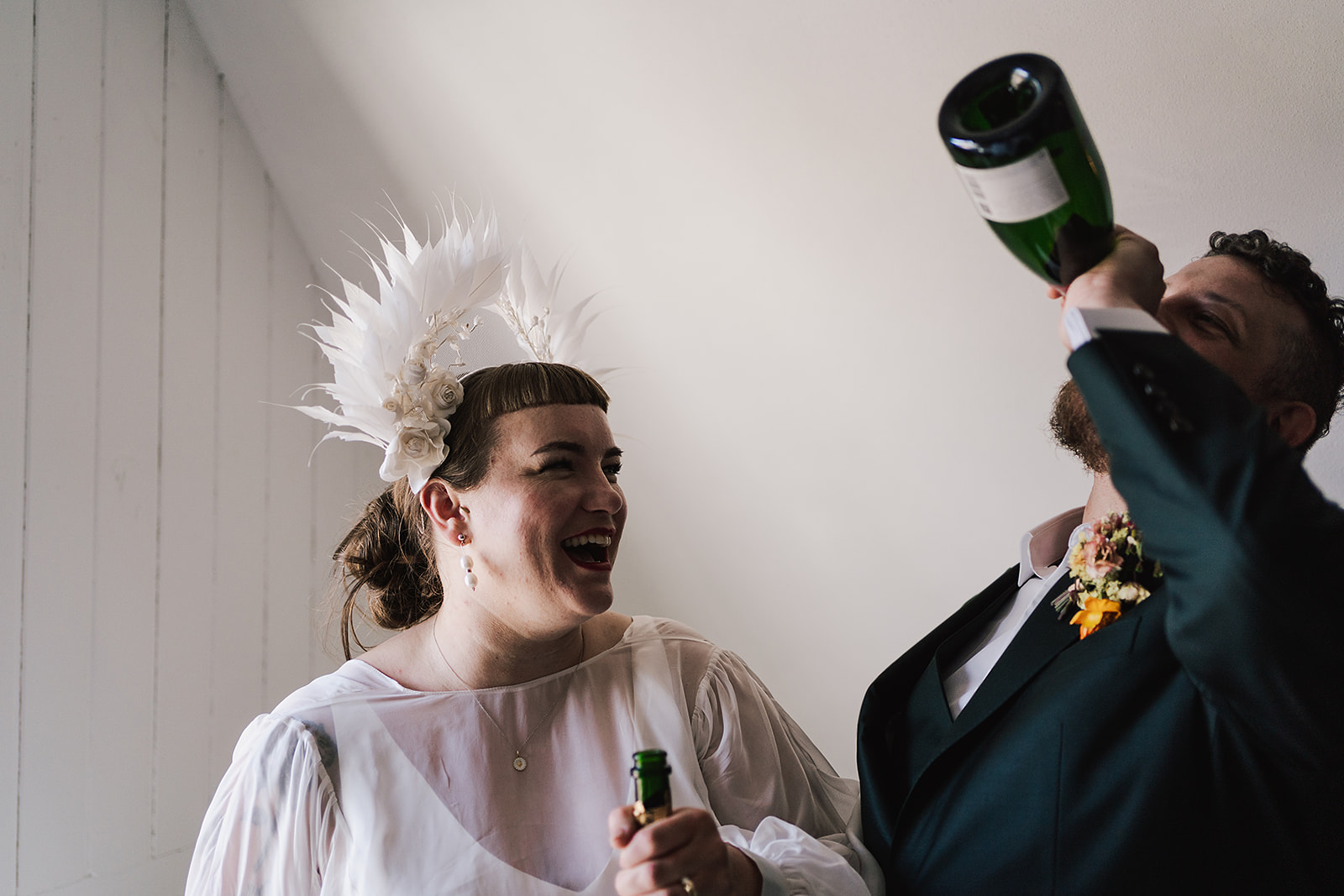 groom drinking from champagne bottle