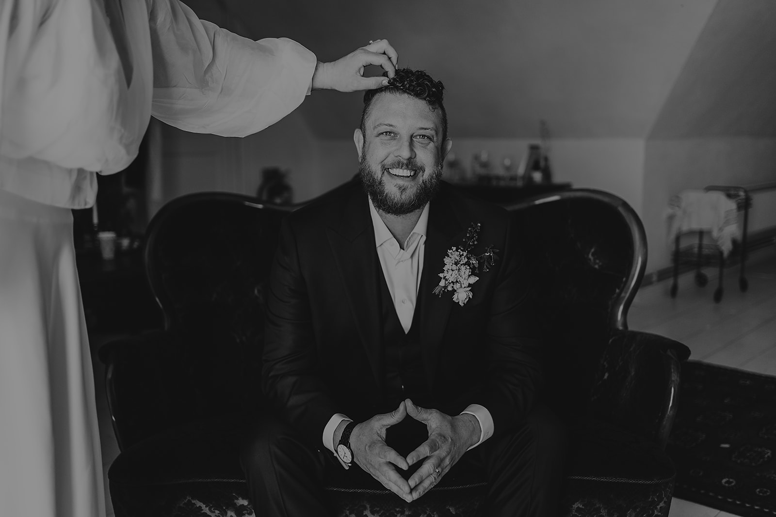 bride tweaking grooms hair during portraits