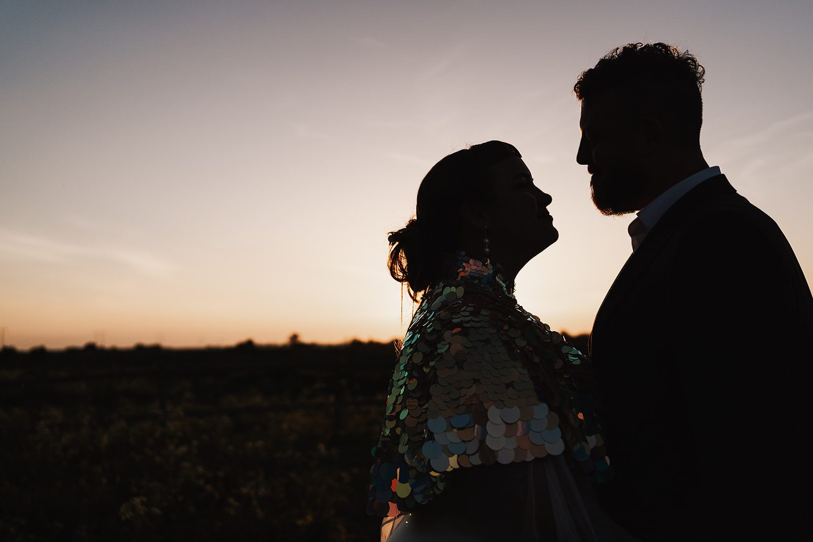 bride and groom silhouette at sunset