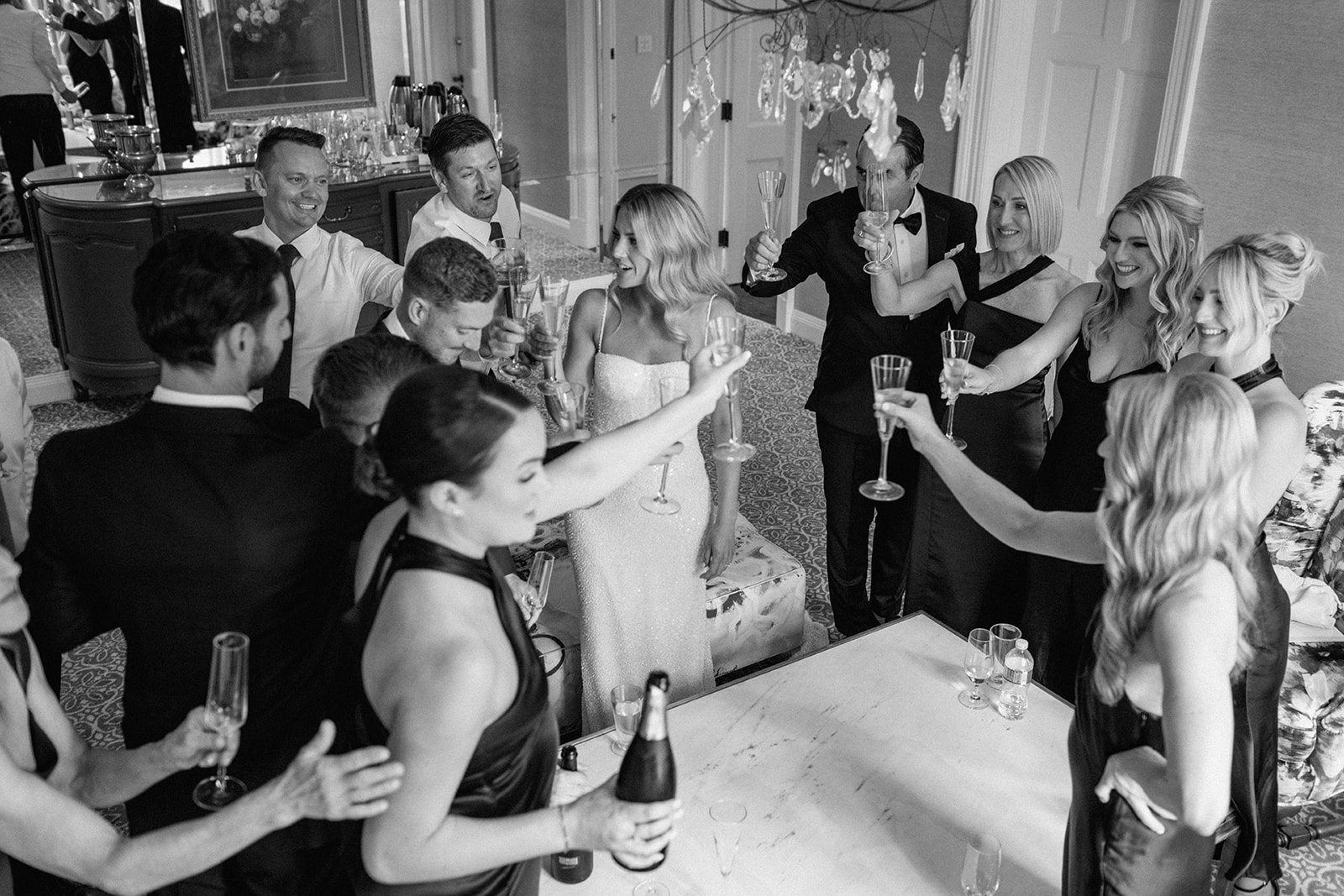 Couple and bridal party cheers before ceremony at Graydon Hall Manor