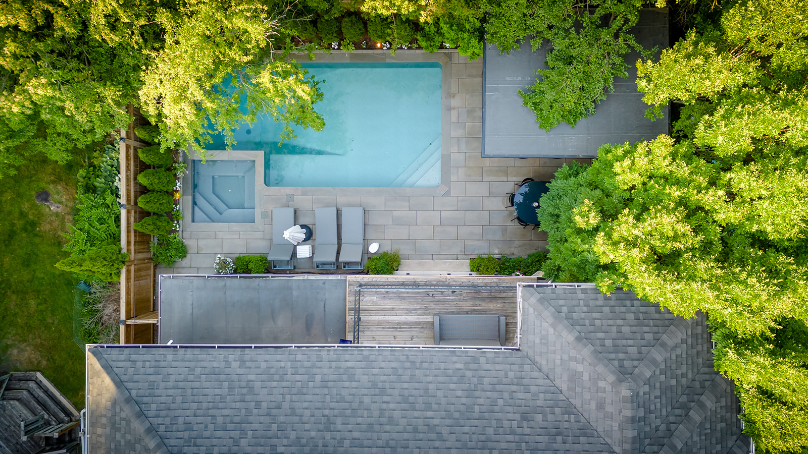 A top-down view of the backyard with an inground pool.