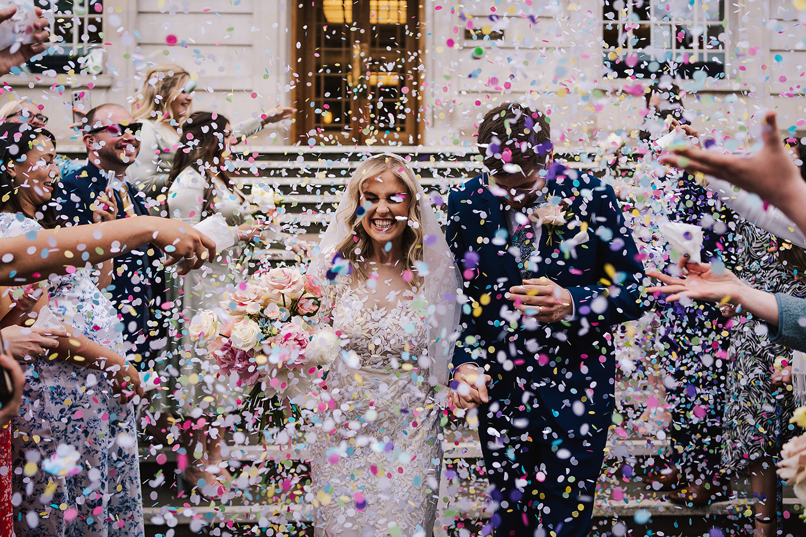 bride and groom in a shower of confetti at Hackney Town Hall