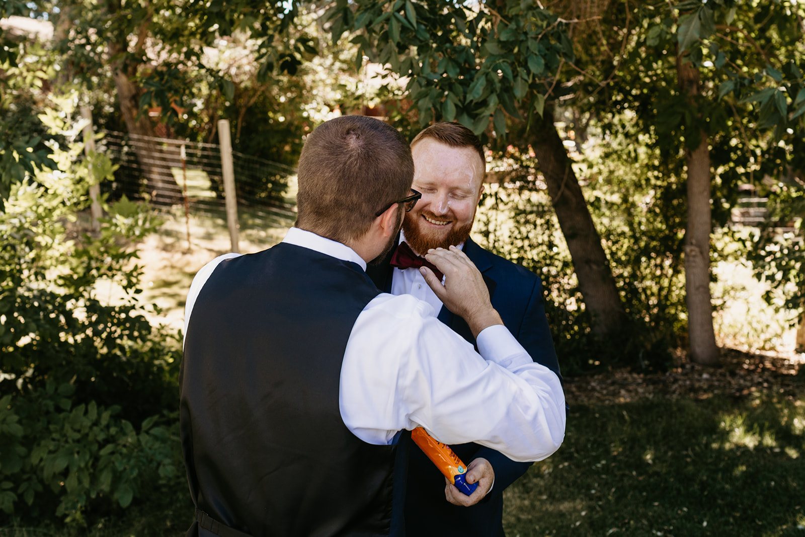 Grooms brother helps groom get ready for the wedding day