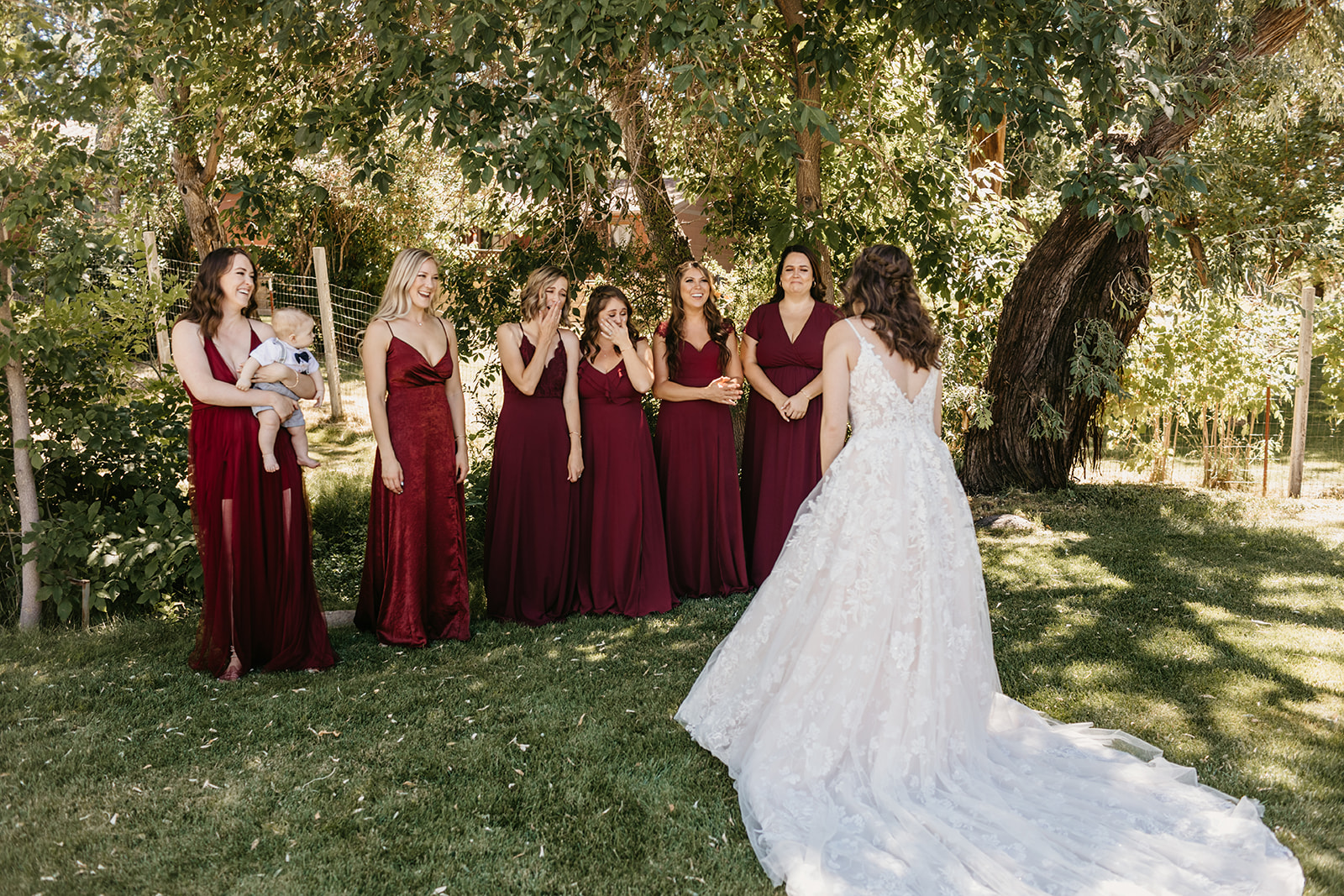 Bride revealing her wedding dress to her bridesmaids