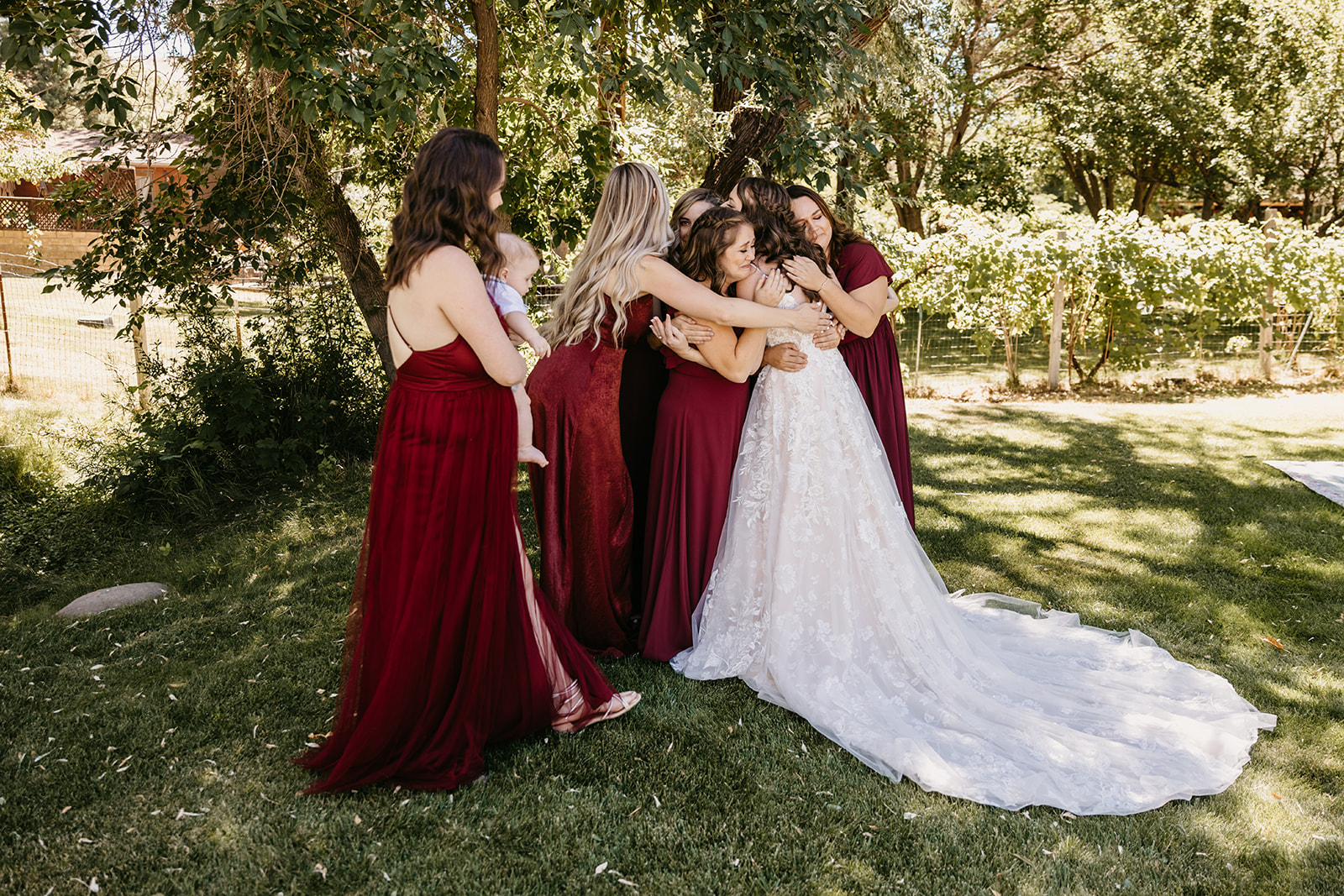 Bride revealing her wedding dress to her bridesmaids