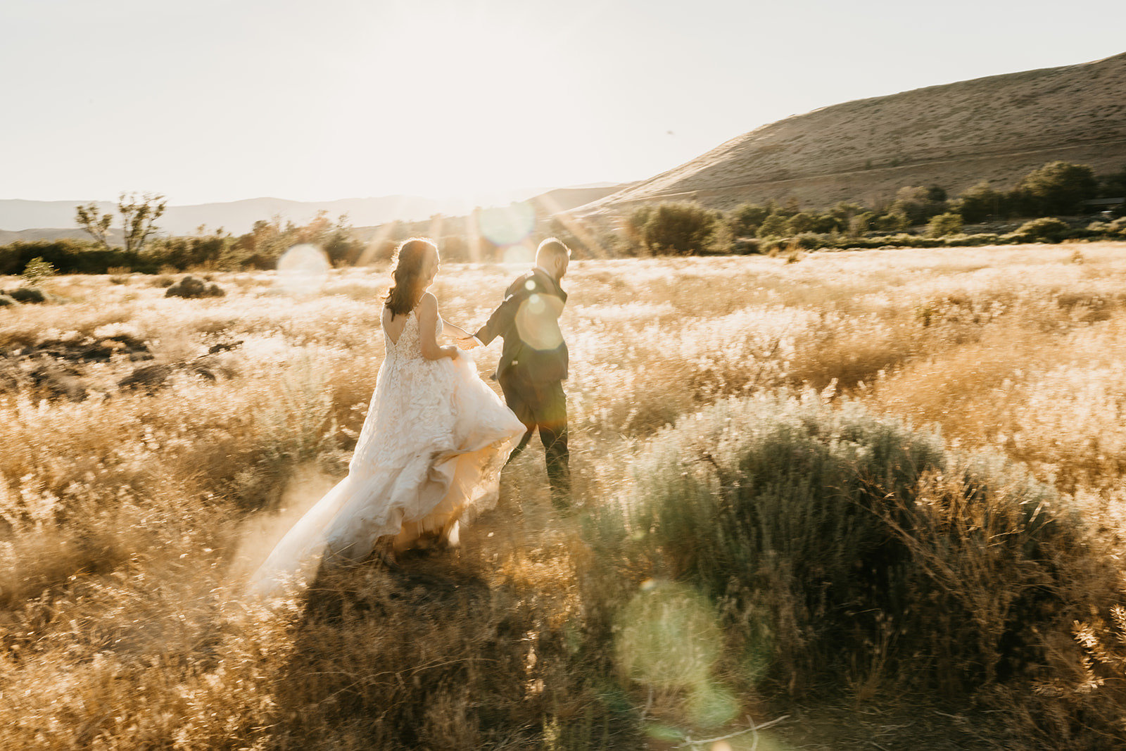 Bride and groom take couples photos in a golden field in Reno Nevada