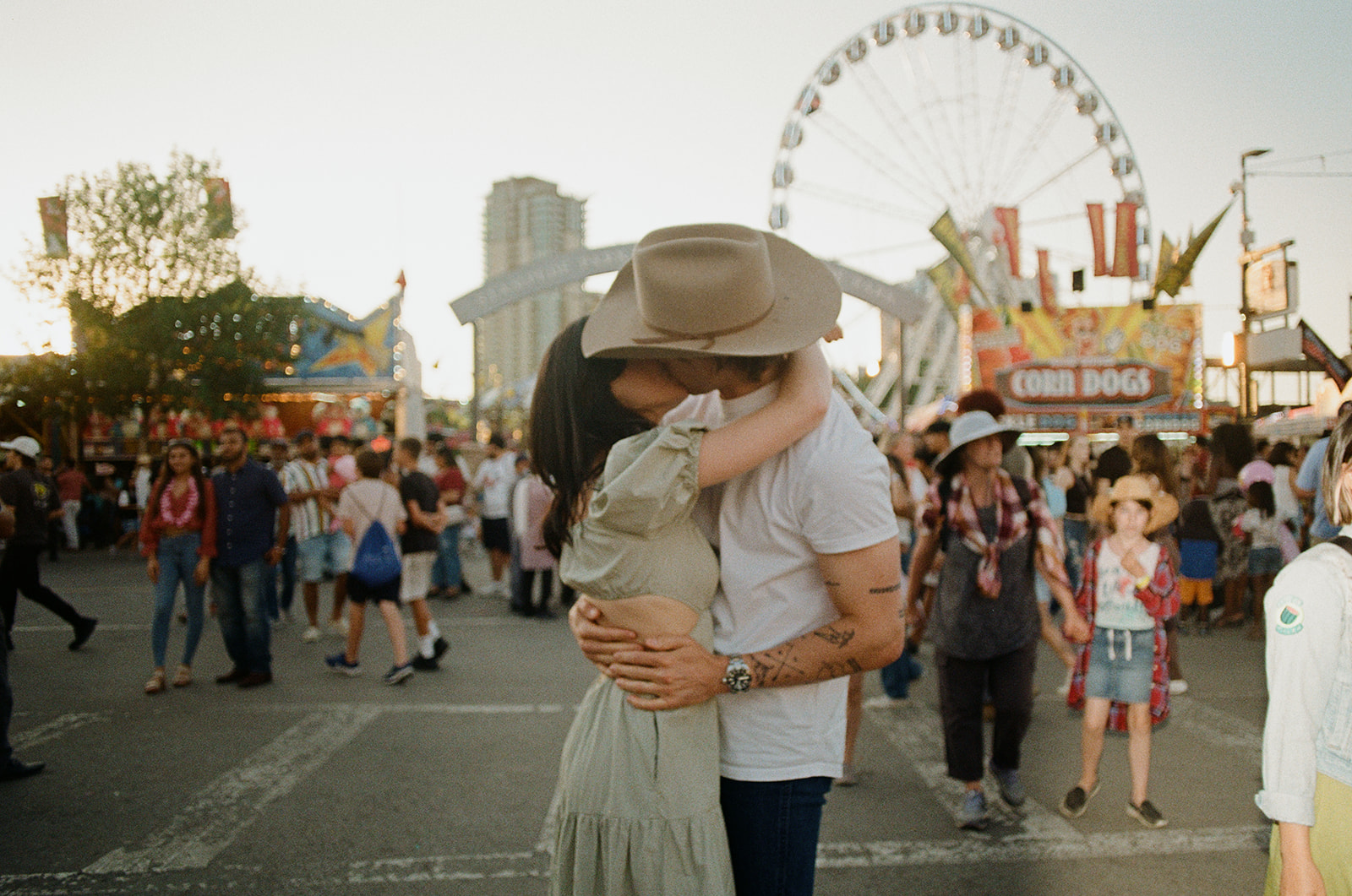 35mm film photo of engaged couple kissing at the calgary alberta stampede