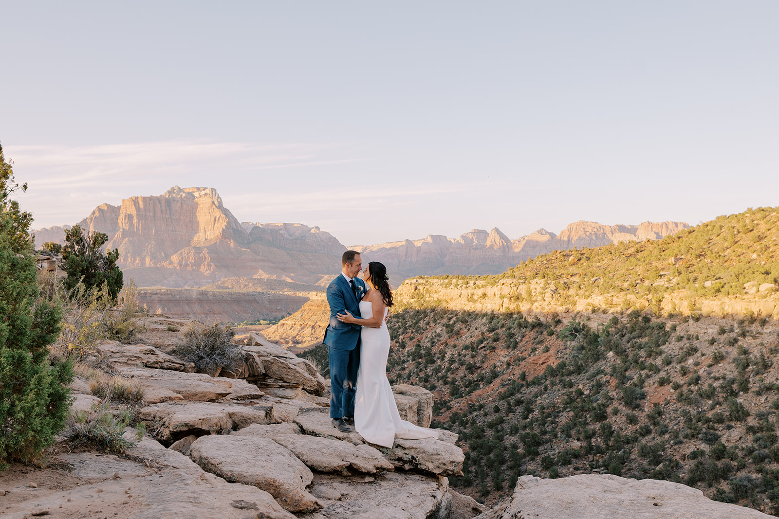 A couple who got married at sunset with Zion National Park in the background.