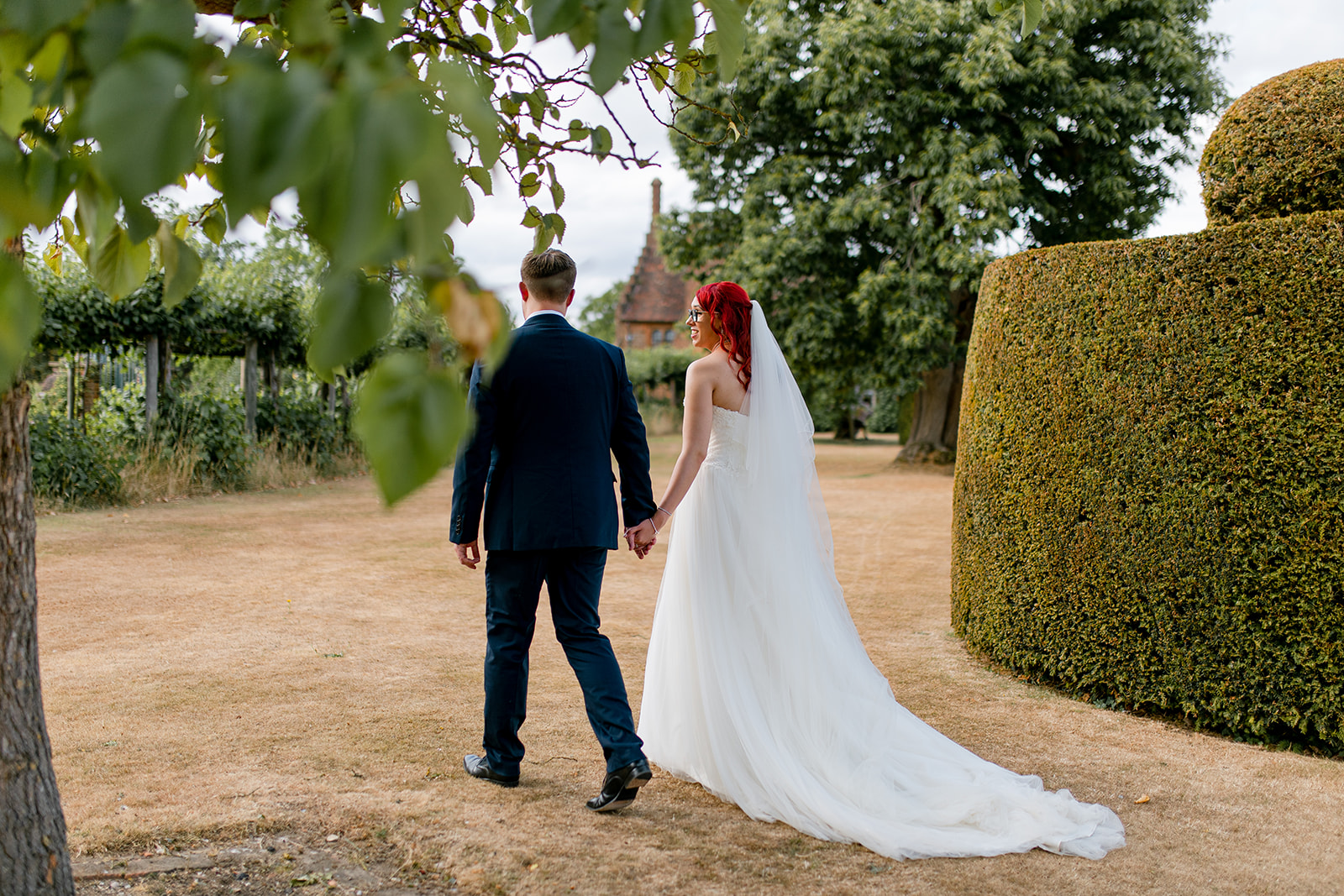 A couple who just got married, enjoy a walk around the gardens at Hatfield House