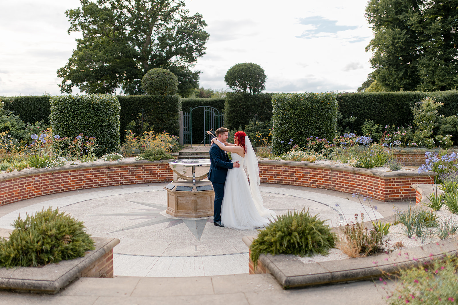 A couple who just got married, enjoy a walk around the gardens at Hatfield House