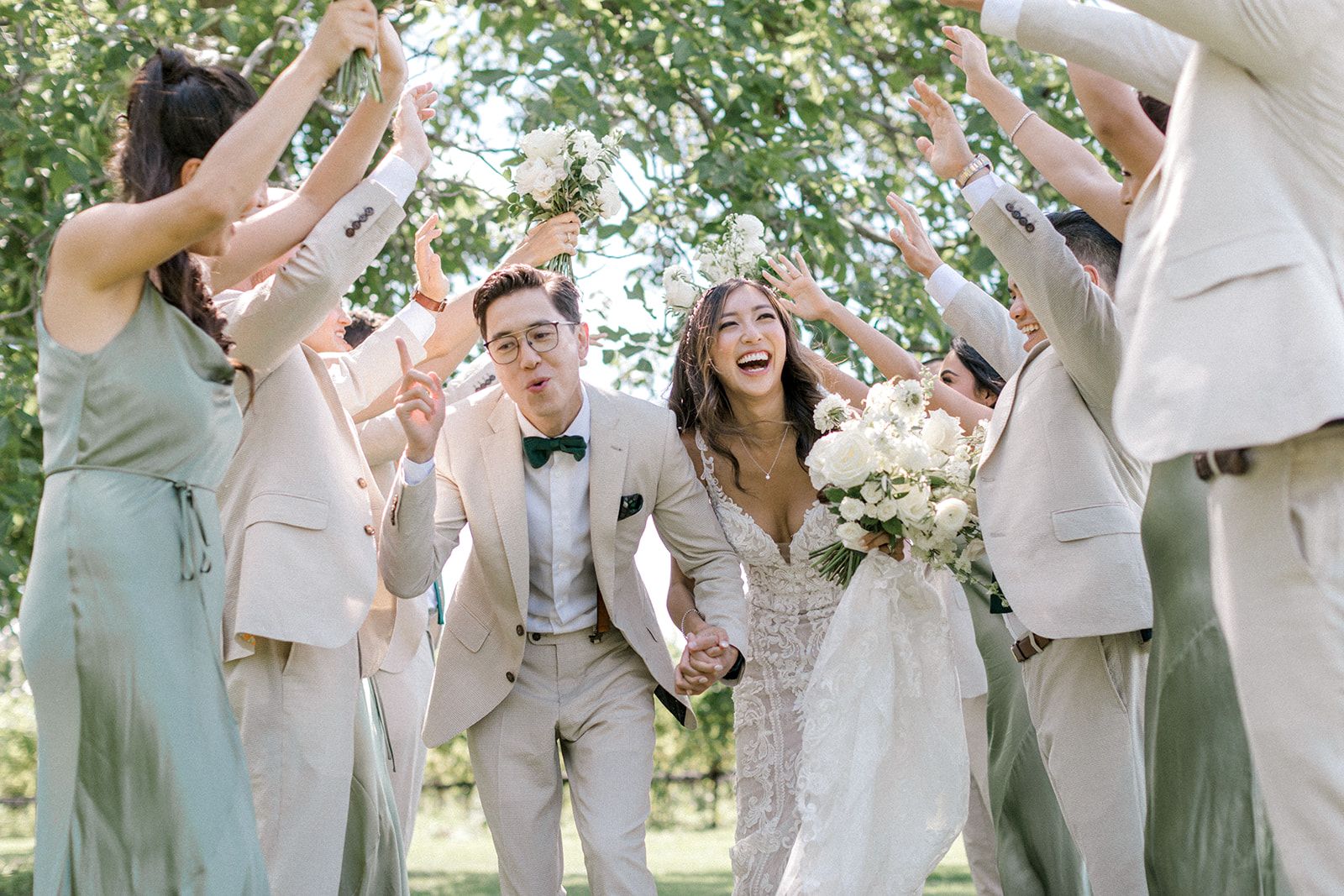 Bridal Party laughs and celebrates during portrait photos on wedding day 
