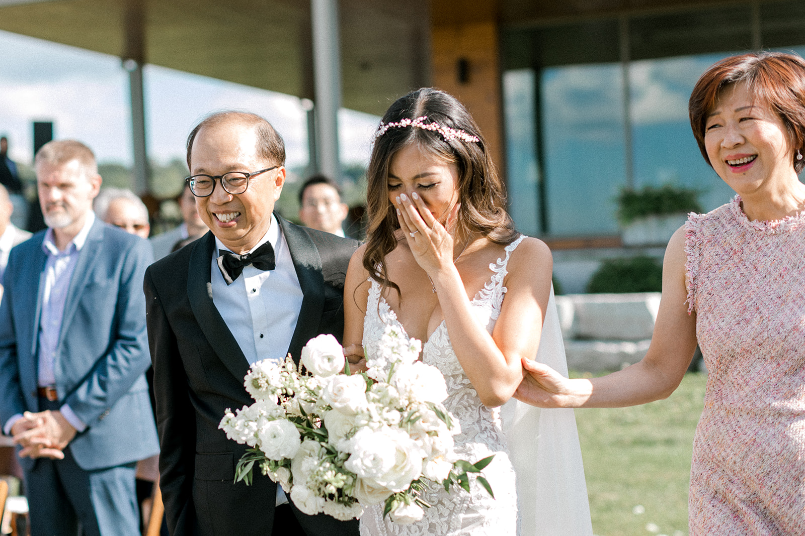 Bride holds back emotion as she walks the aisle during her wedding ceremony at Ravine Vineyard Estate Winery