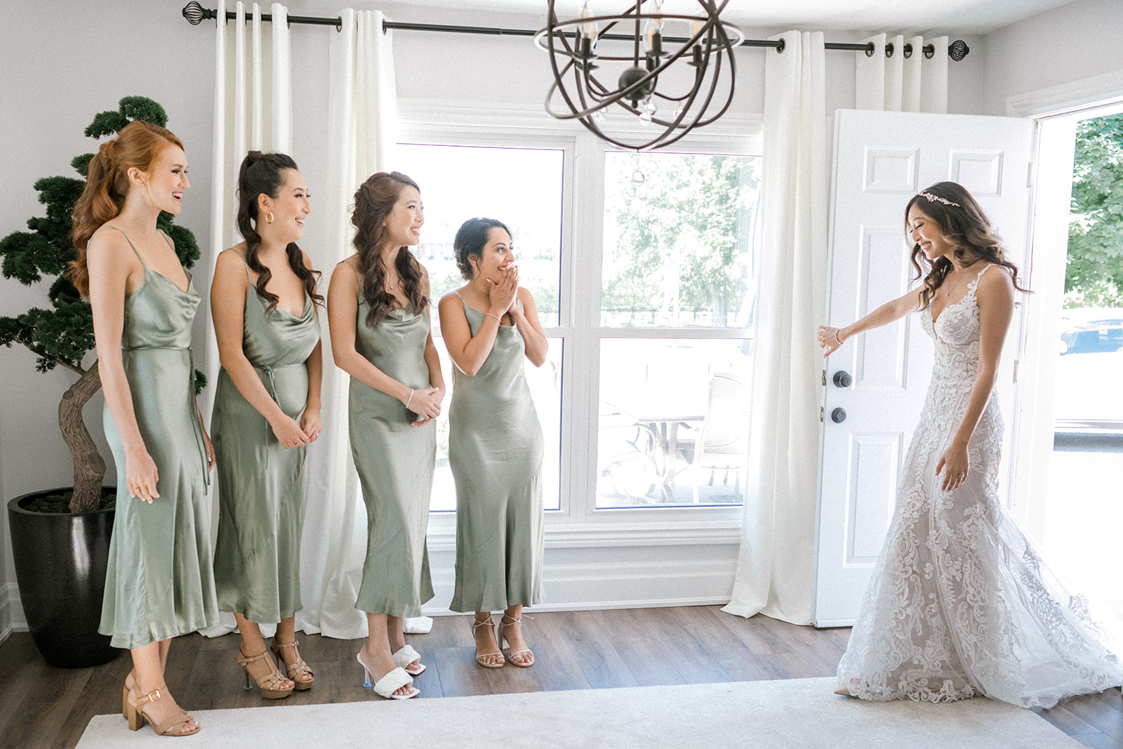 Bridesmaids react to seeing the bride for the first time on her wedding day 