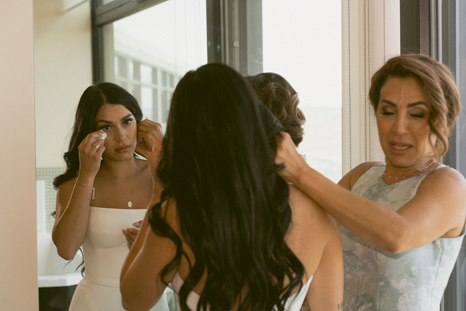 Details of putting on her wedding dress, mom and daughter crying