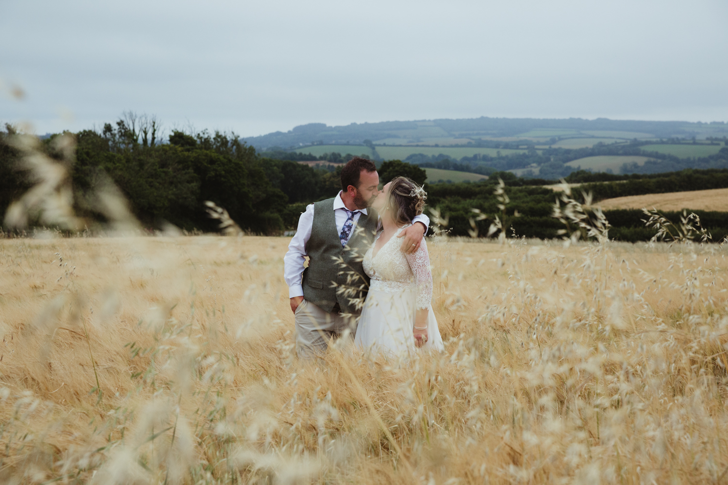 bride and groom portraits in a field at dusk