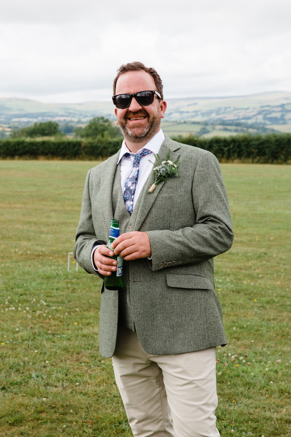 portrait of a groom with views over Dartmoor in the background 