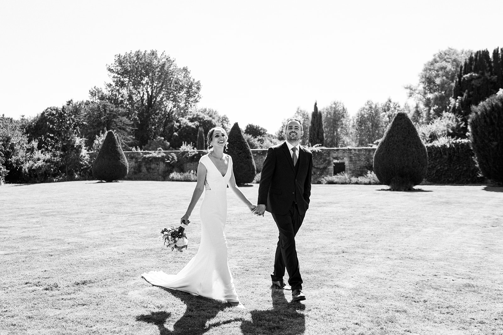 A natural black and white image of the couple looking at Brympton House