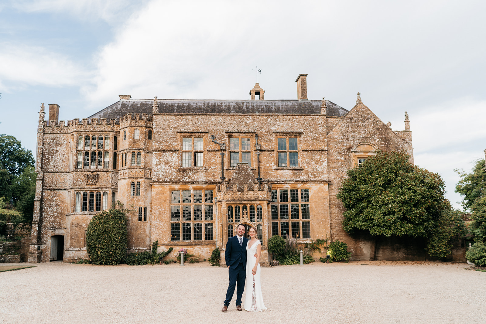 The bride and groom infront of the stunning Brympton House in Somerset