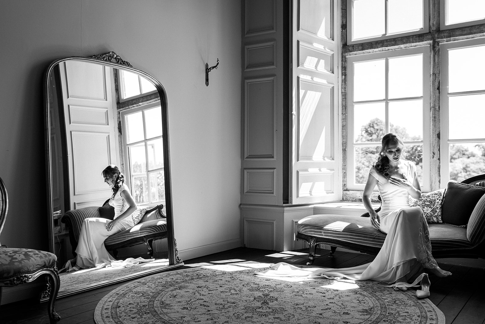 The bride putting on her shoes in the stunning bridal suite