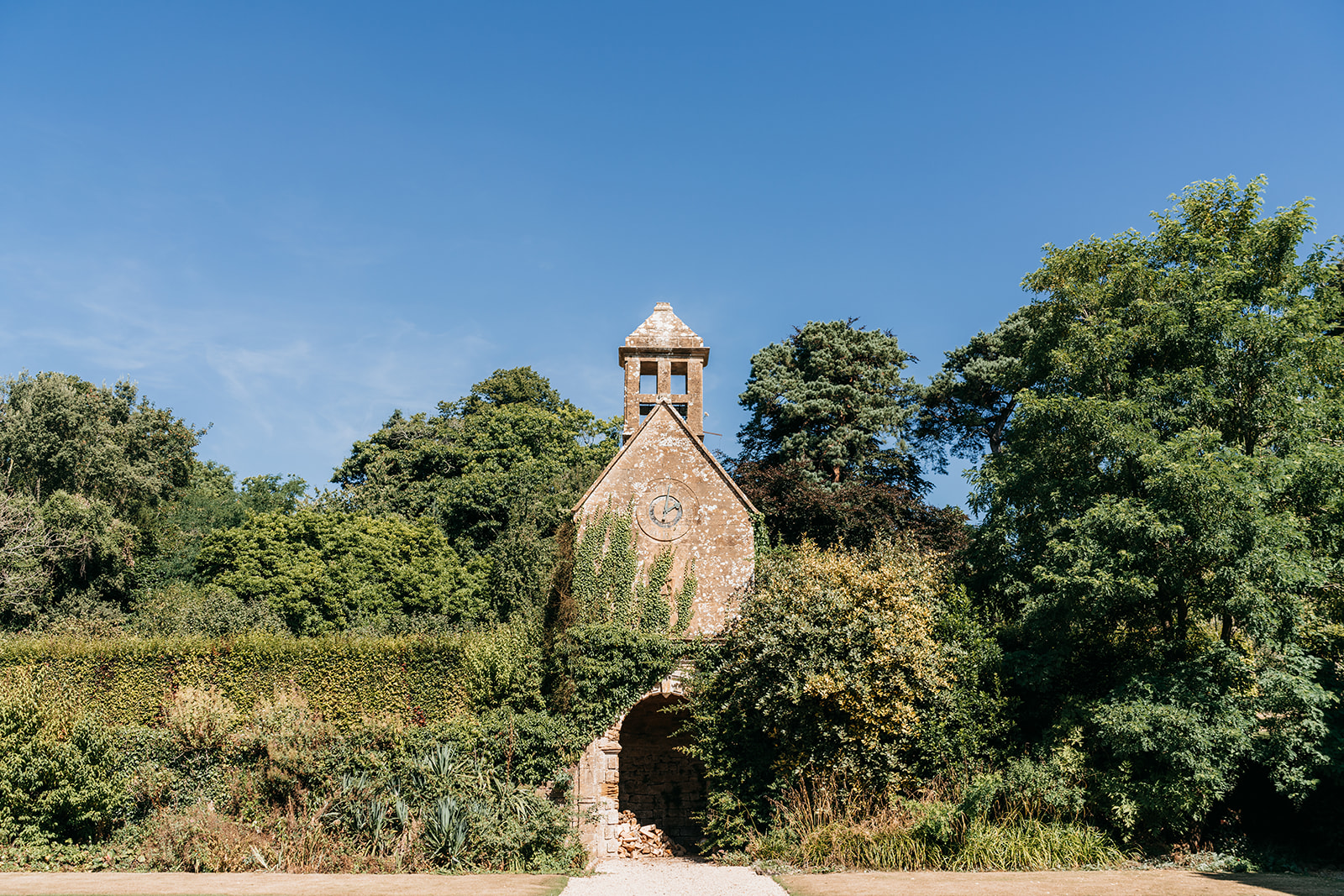 the clock tower at Brympton house surrounded by greenery