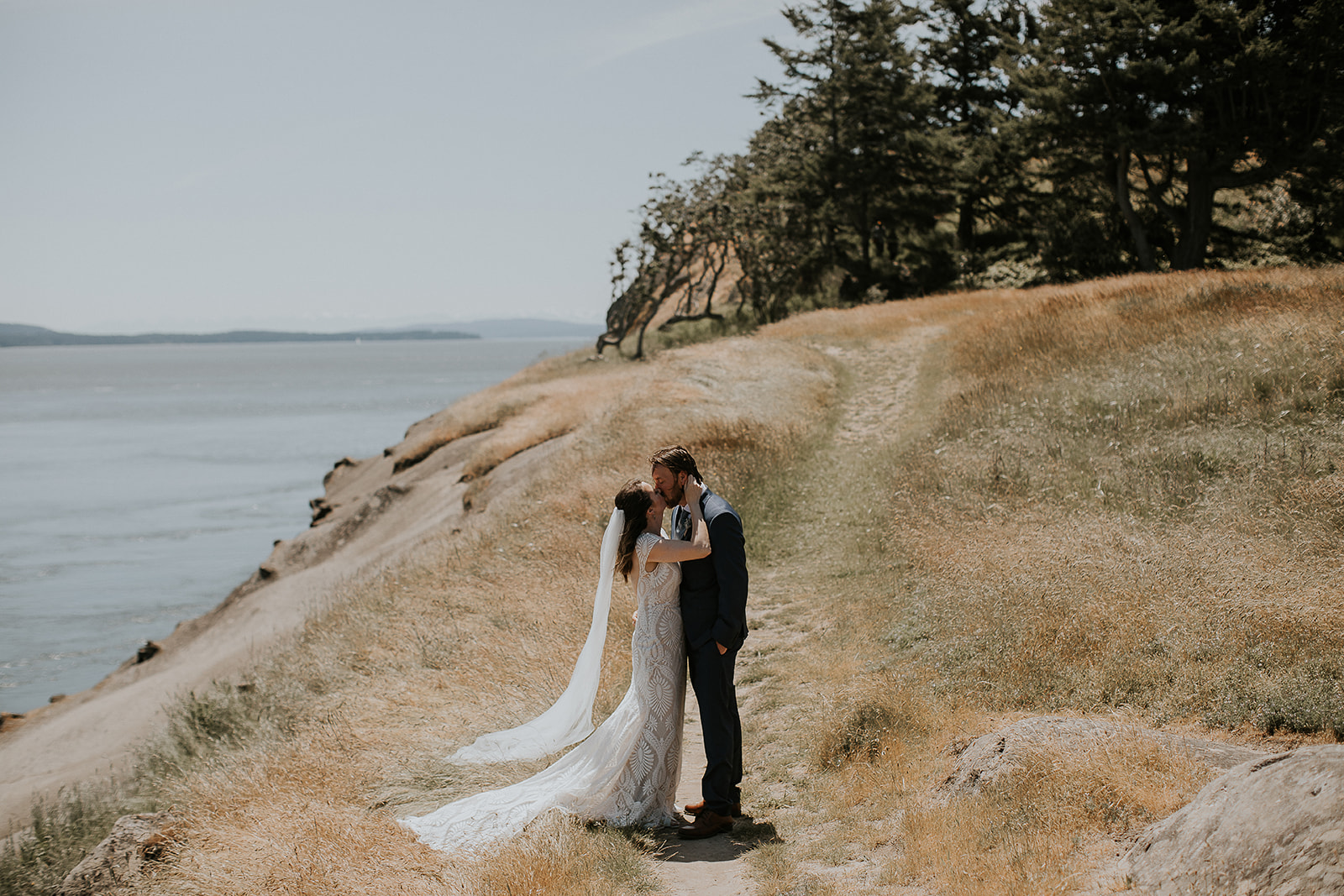 A bride and groom kiss at East Point Park 