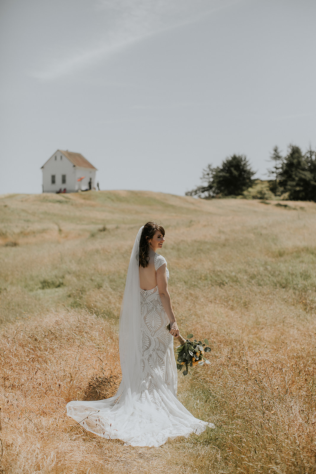 a bride looks over her shoulder on Saturna Island 