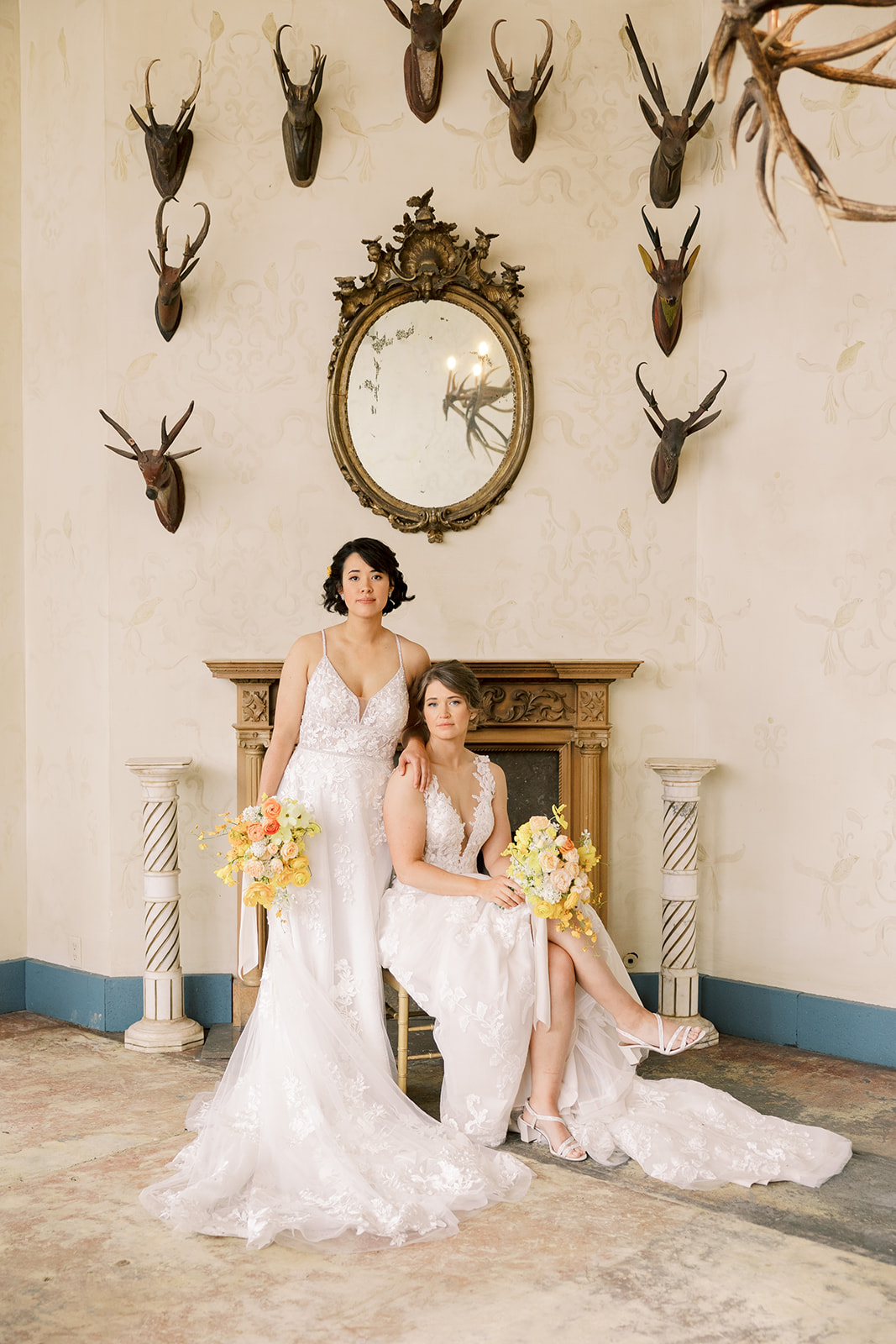 one bride stands next to a chair with another bride sitting