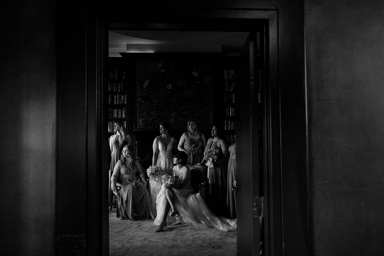 view through a door of a bride and bridal party around them