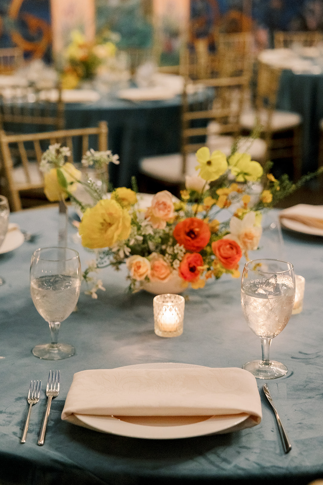 wedding tablescape with orange and red and yellow flowers
