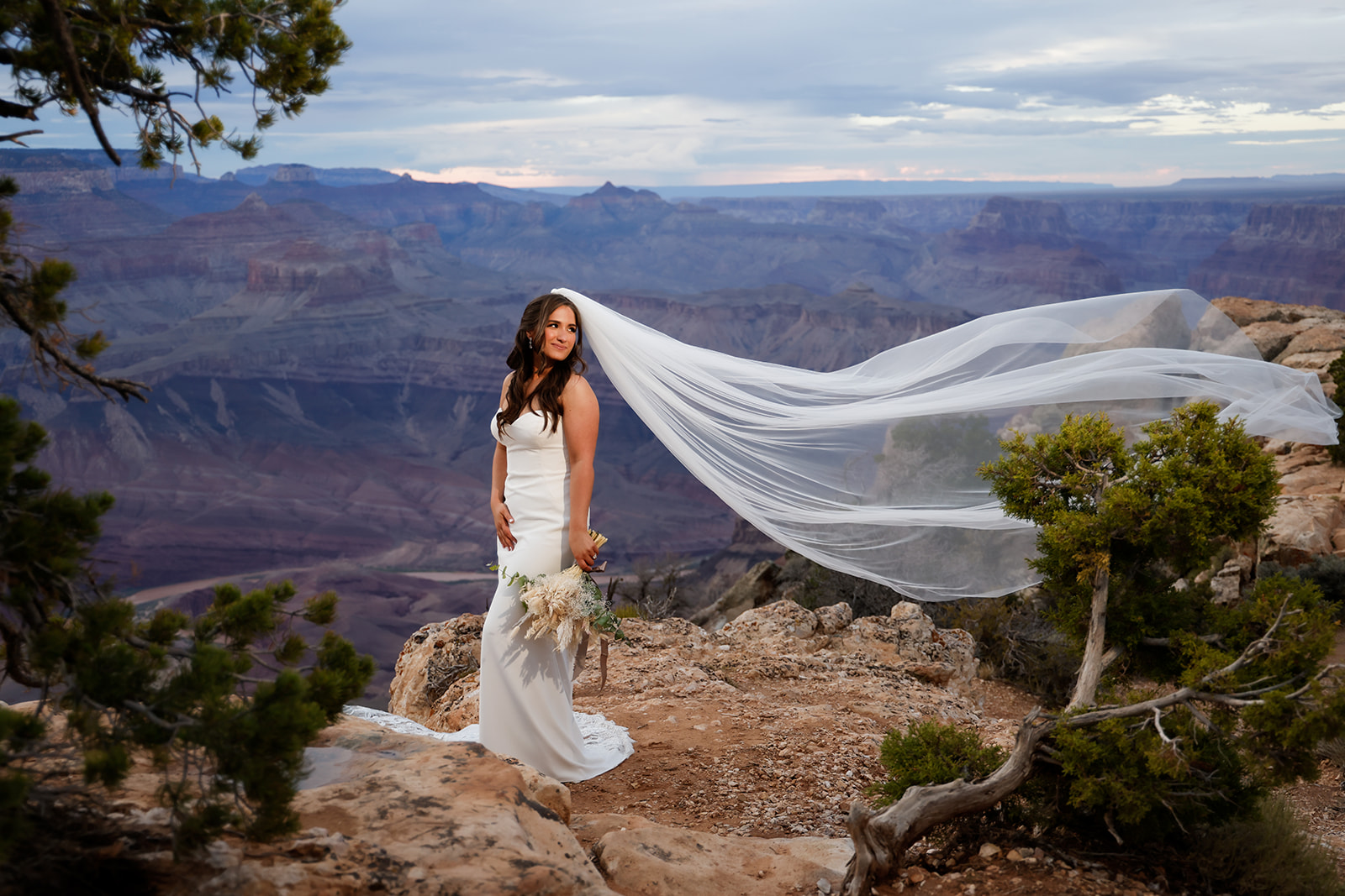 Grand Canyon Romantic Wedding of bride portrait with veil in the wind. Arizona wedding photographers Heather Kadar