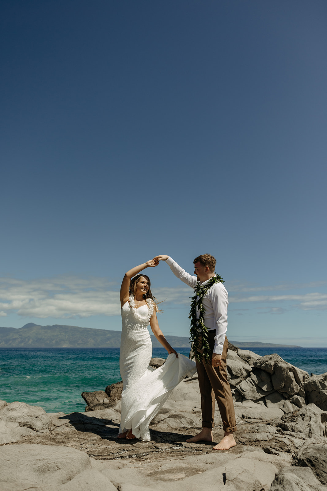 Couple eloped at the Ironwoods Beach in Maui, Hawaii wearing traditional lei