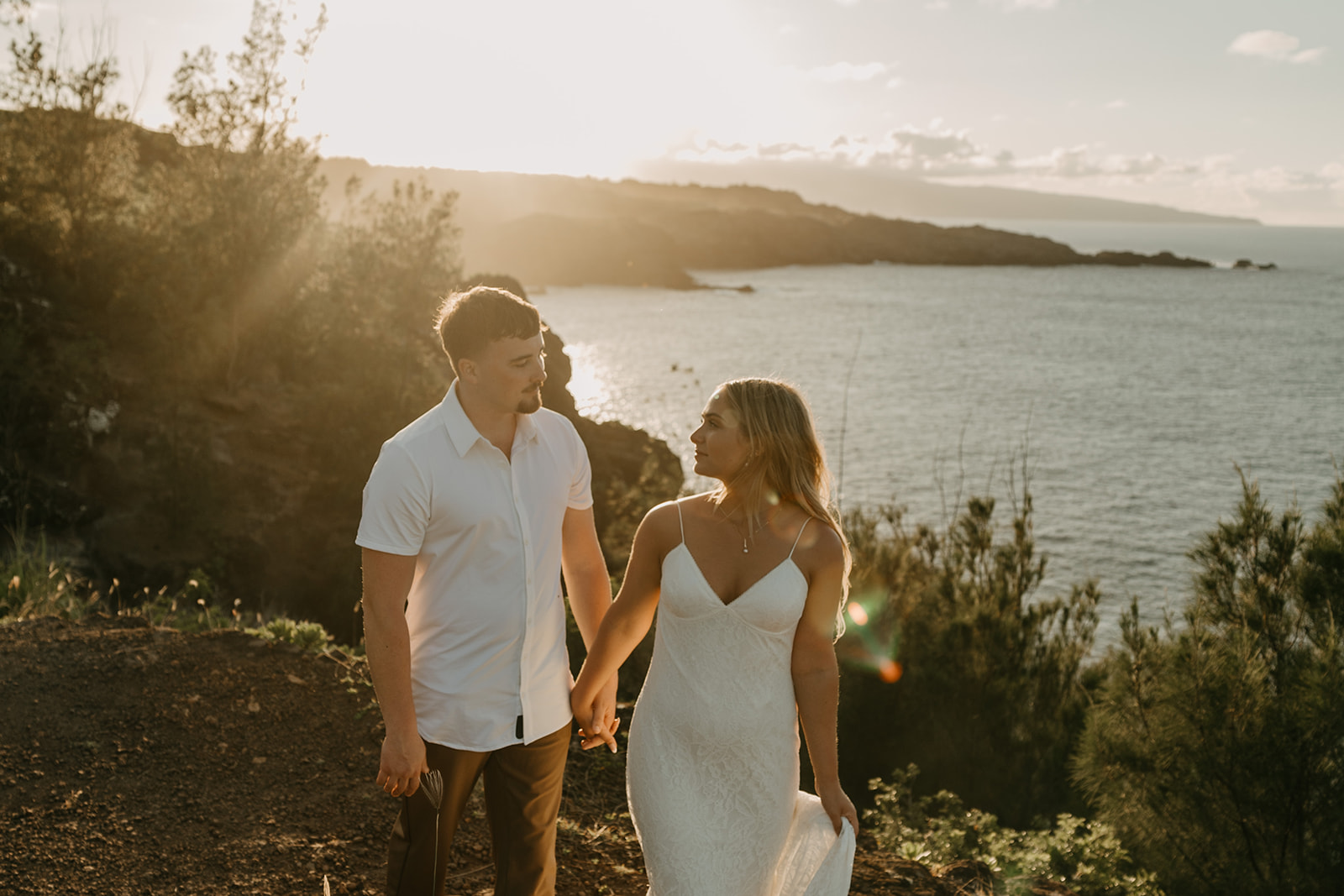 A couple who eloped in Maui, Hawaii overlooking the ocean during sunset