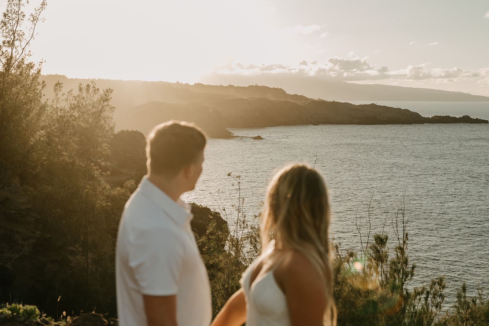 A couple who eloped in Maui, Hawaii overlooking the ocean during sunset