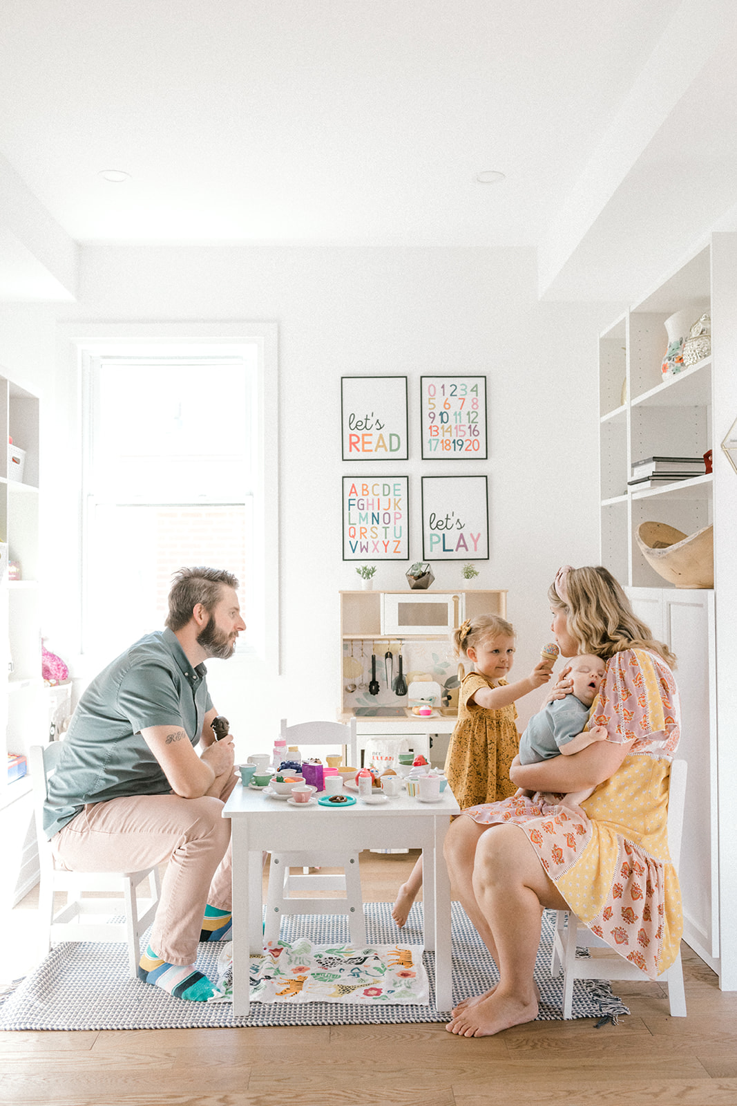 Family sits in living during family photoshoot