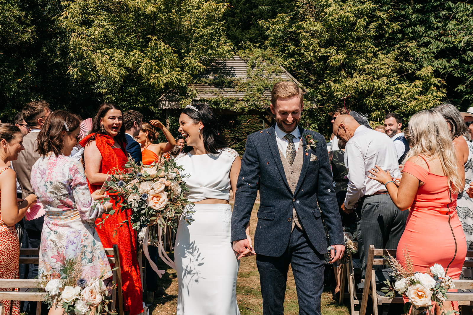 Bride and groom exiting with confetti petals
