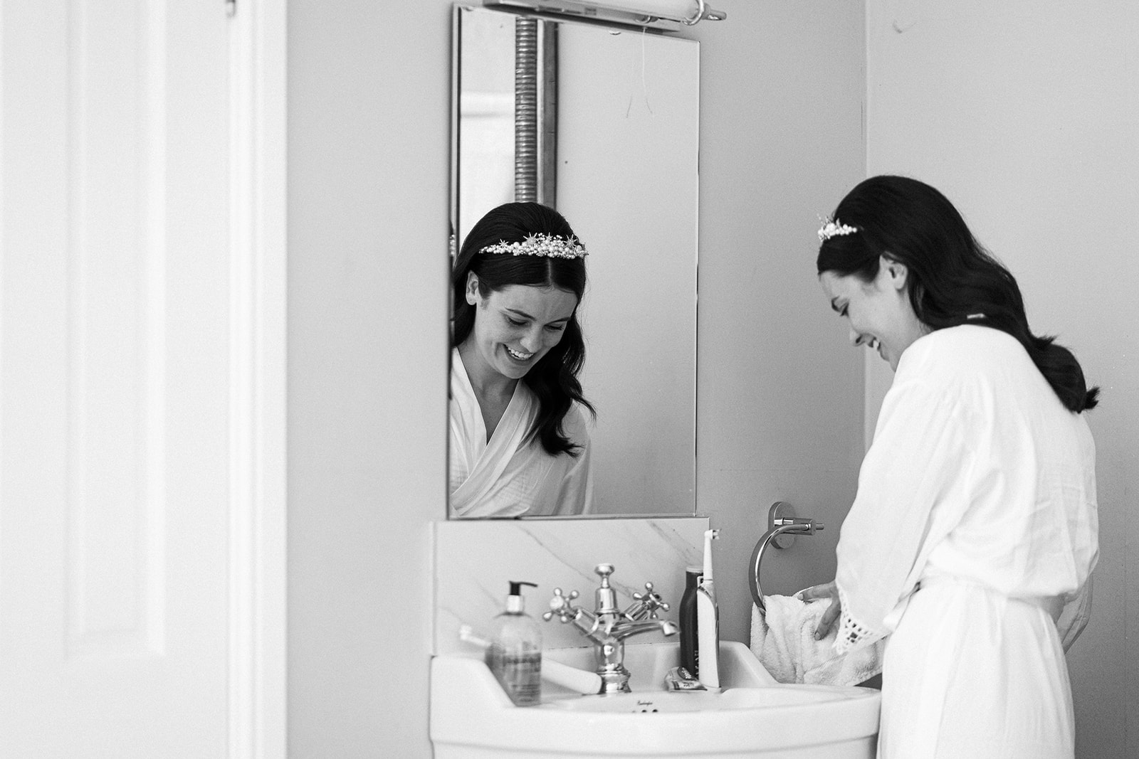 Bride looking at herself in the mirror on the morning of her wedding