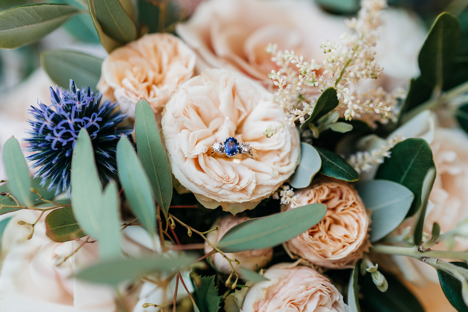 Brides engagement ring placed in her wedding flowers. Wedding flowers by Alexandra Sylvester flowers