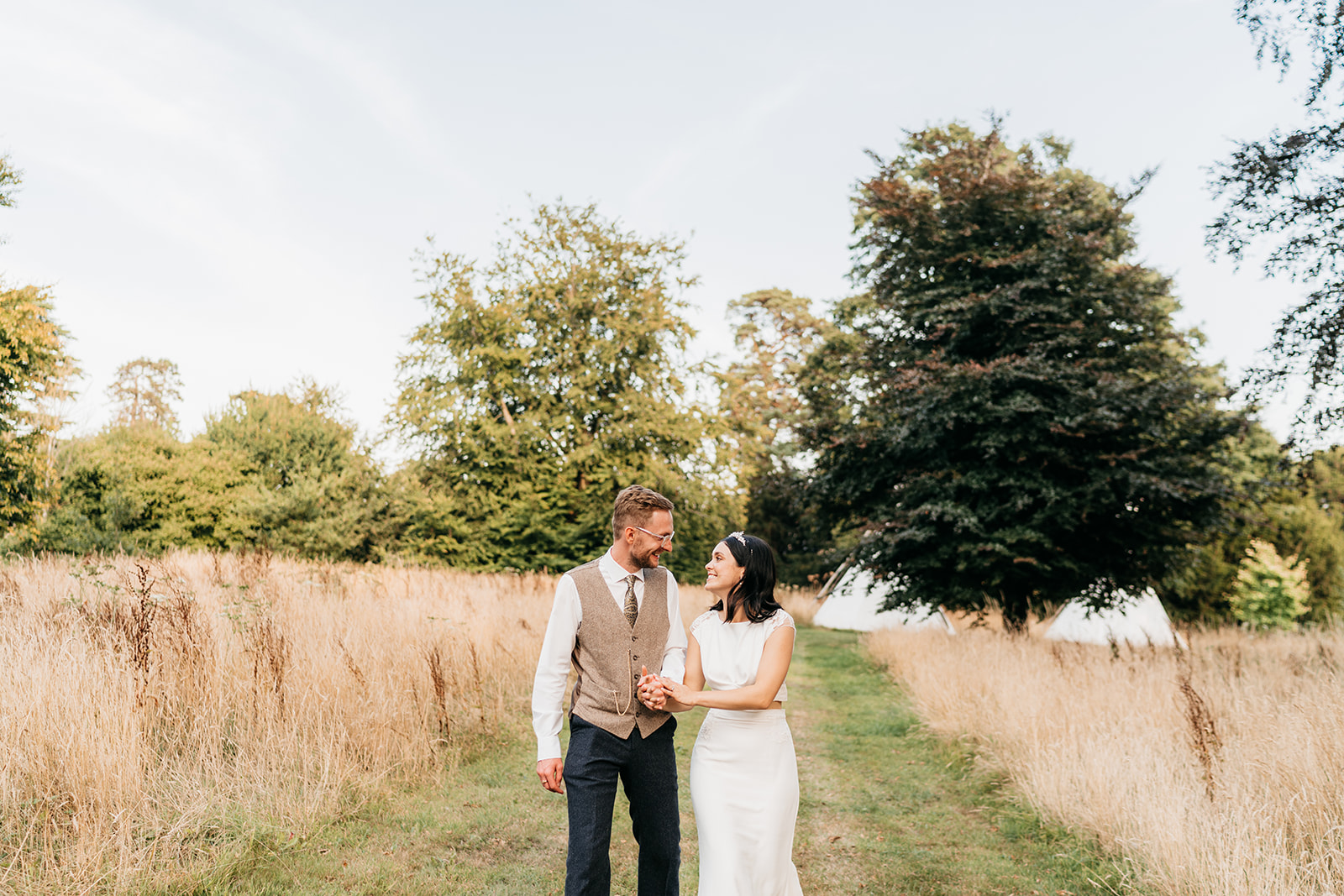 The bride and groom stood in the lovely long grass