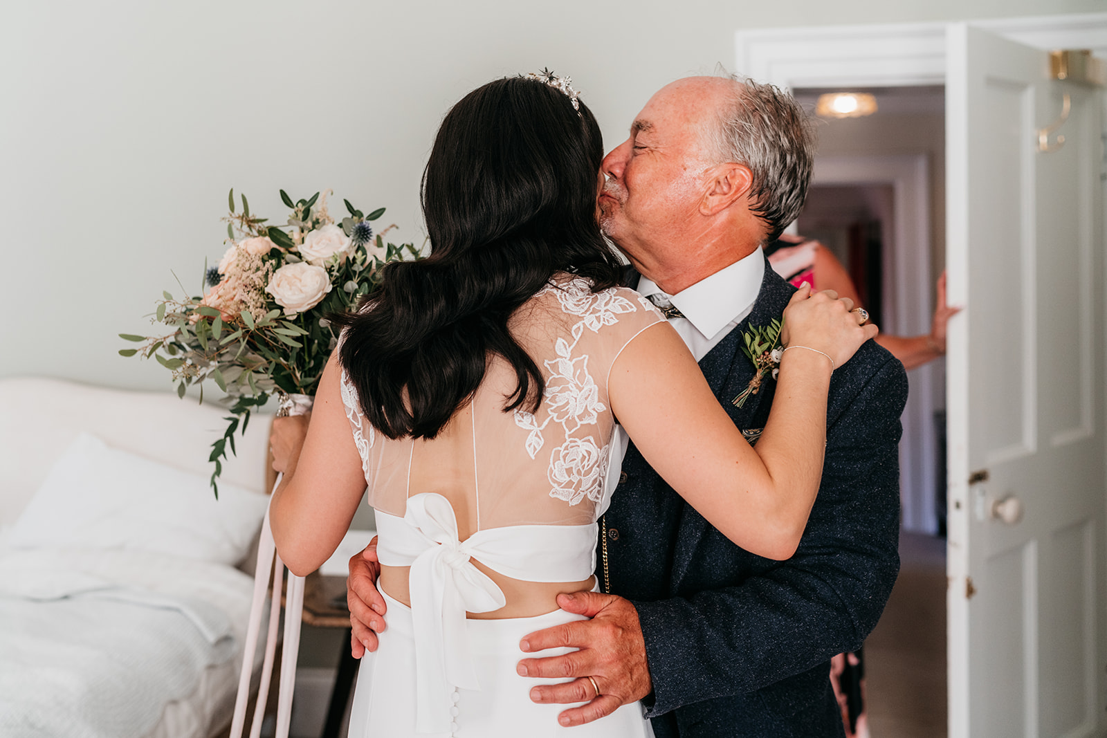 The bride and her dad sharing a hug before the walk down the aisle
